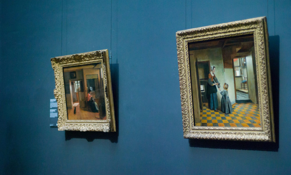 zwei Gemälde vor blauer Wand im Rijksmuseum