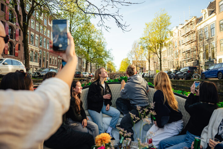 People on a boat tour. Amsterdam city sightseeing.
