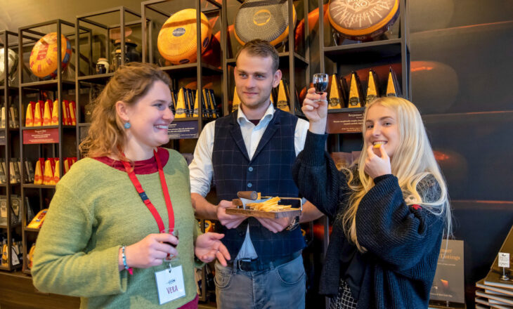 Two women and a man tasting cheese in Amsterdam
