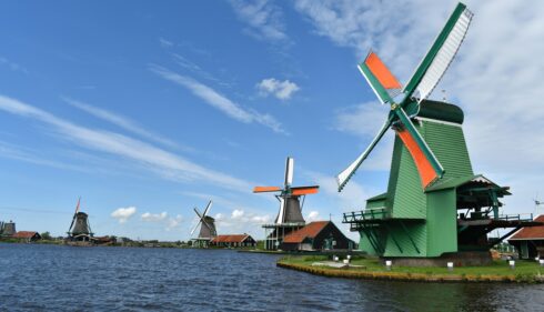 Traditional Dutch windmills on a lake. Classic Dutch scenery.