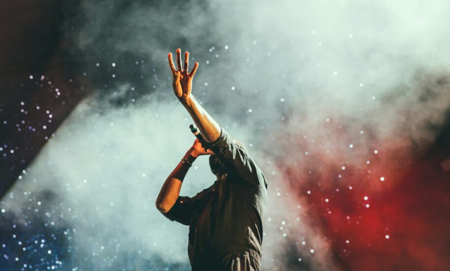 Person in a dark setting with smoke and confetti. Amsterdam's vibrant nightlife scene.