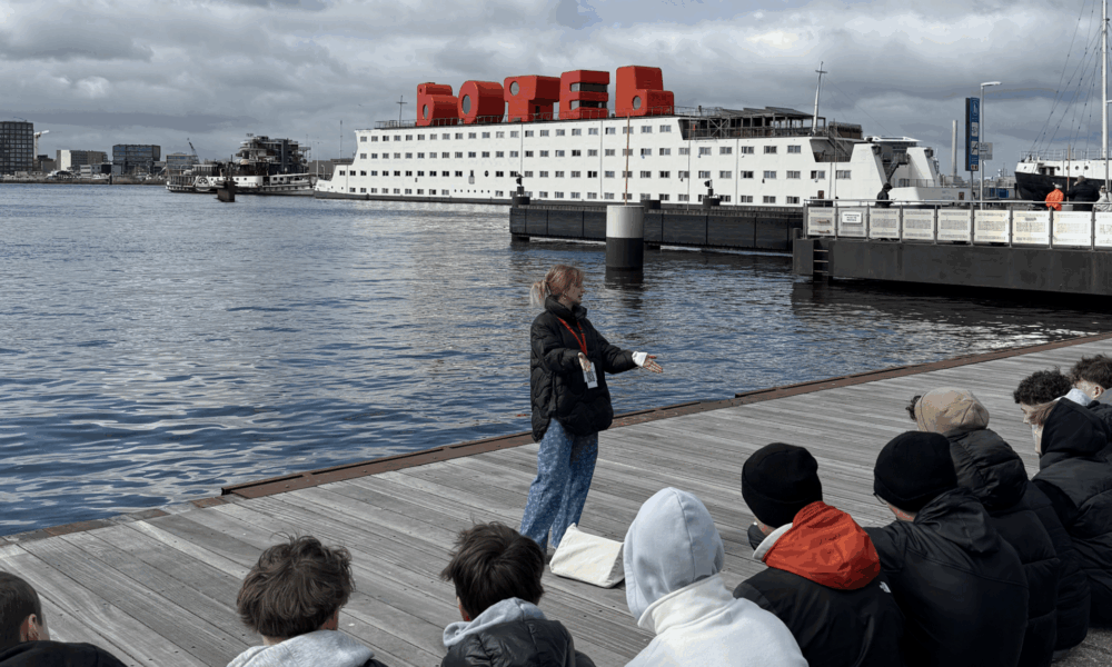 A black and white photo of a beachside scene. A dark sky with clouds.