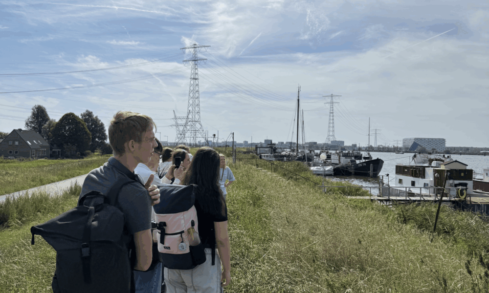 A nighttime view of Amsterdam's canals. The waterway is lit up.