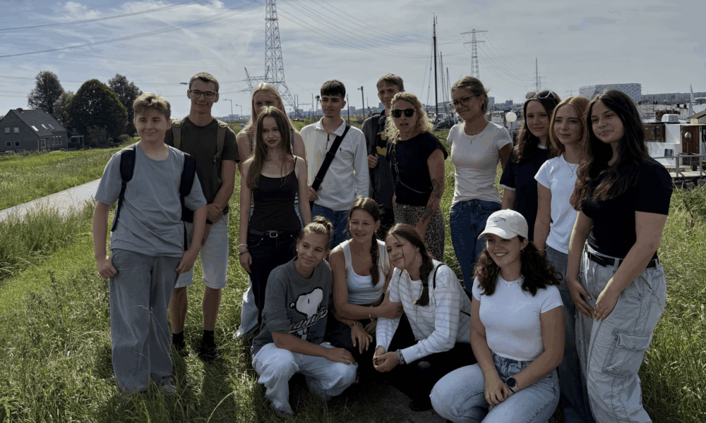 Black and white photo of people. A group of people standing together in Amsterdam.