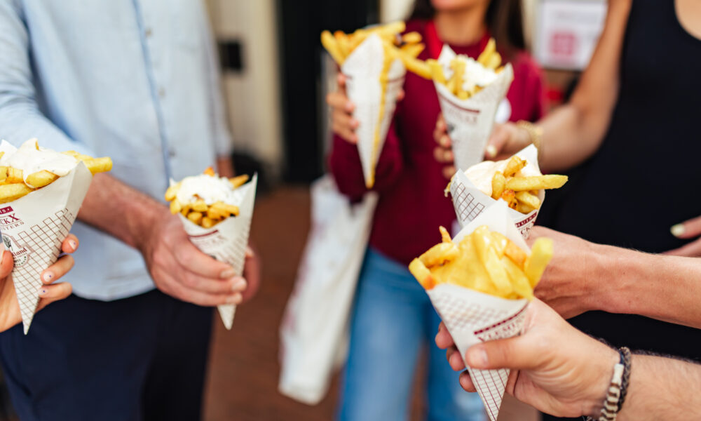 Hands holding snacks in cones