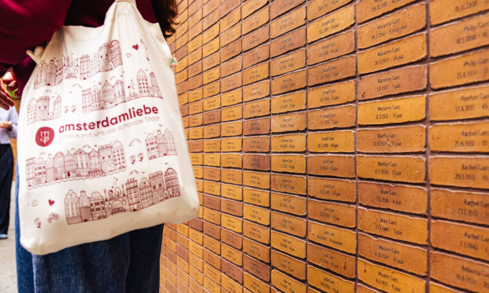 Person holding a bag with an Amsterdam city map