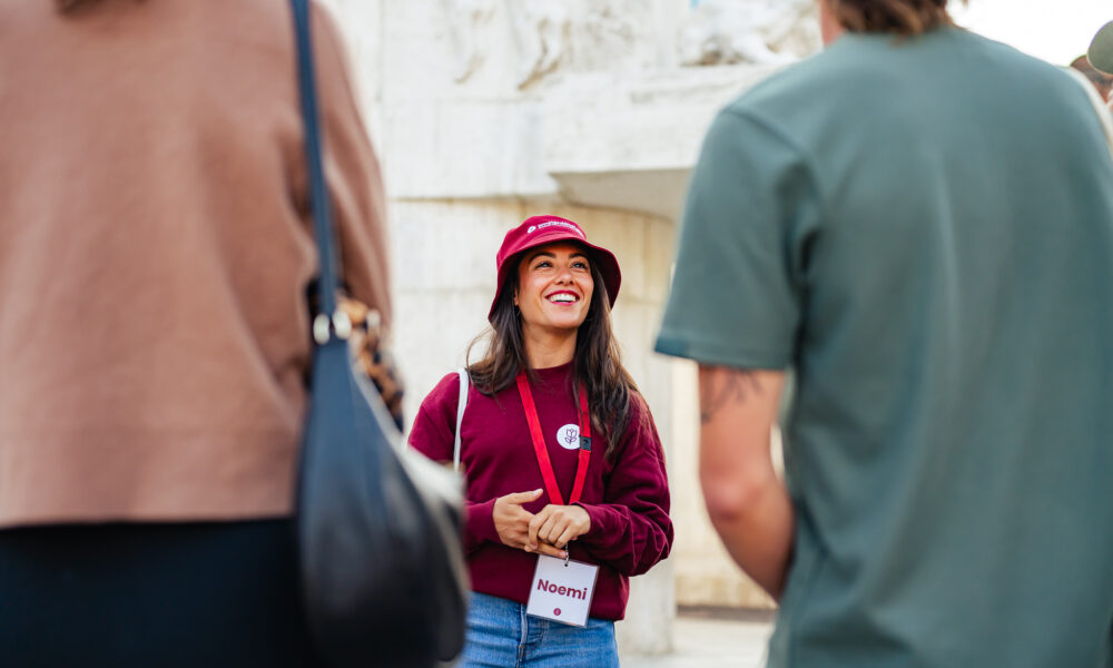 Tour guide talking to tourists. Amsterdam city trip.