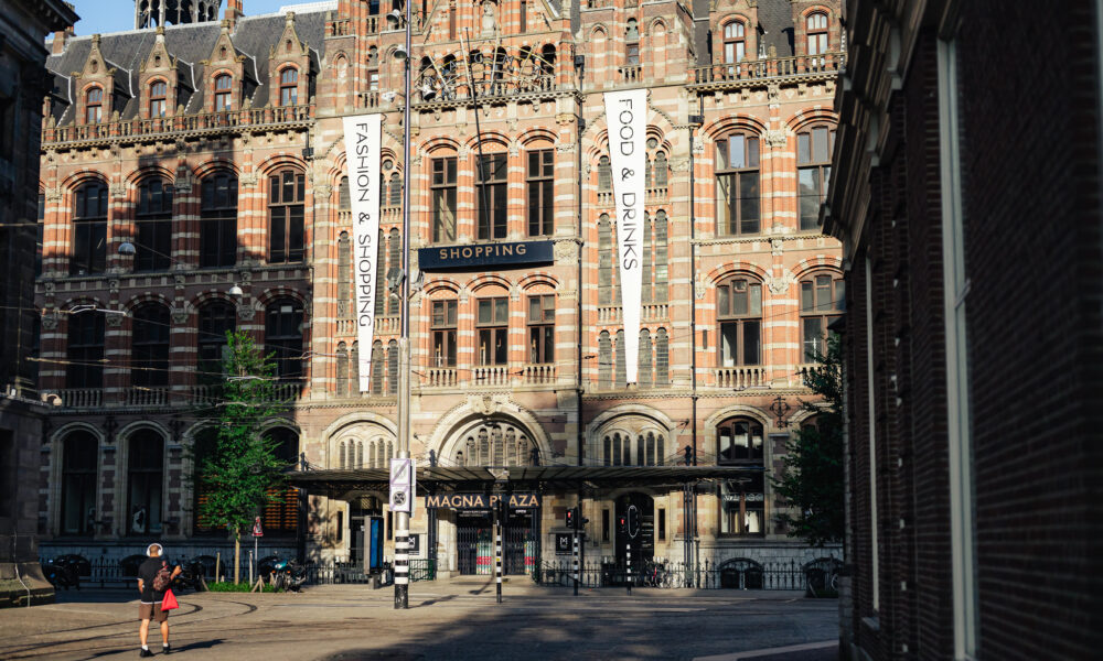 Beurs van Zocher building, a historic stock exchange. A woman walks by.