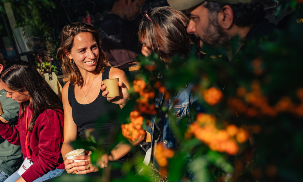 Smiling people sitting among flowers, enjoying Amsterdam
