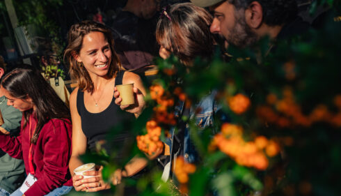 Smiling people sitting among flowers, enjoying Amsterdam