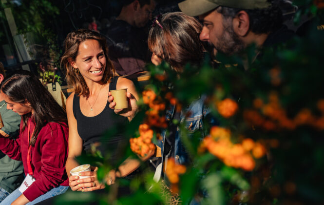 Smiling people sitting among flowers, enjoying Amsterdam