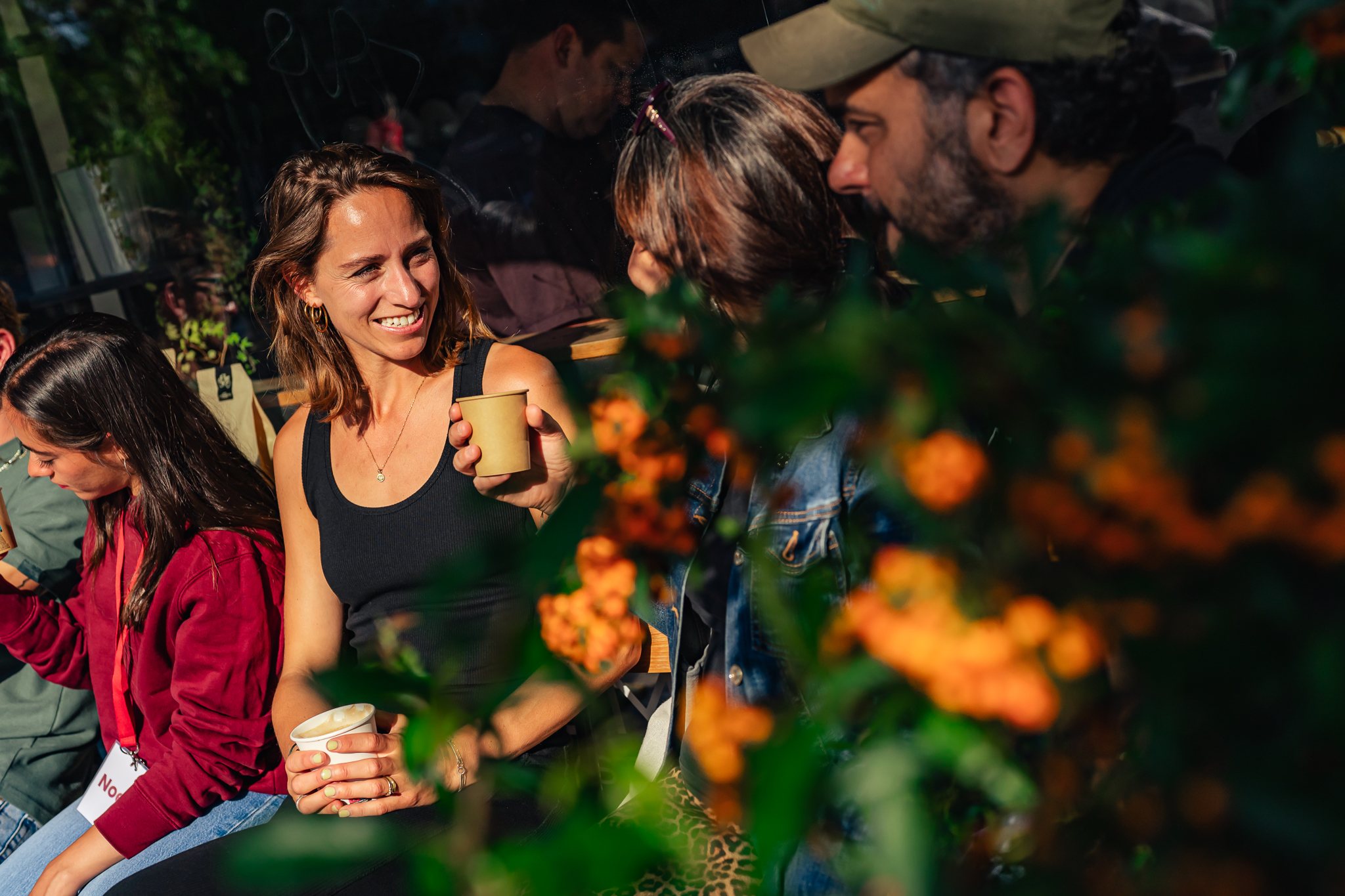 Smiling people sitting among flowers, enjoying Amsterdam