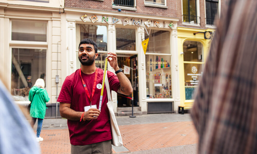 A smiling tour guide in a red t-shirt