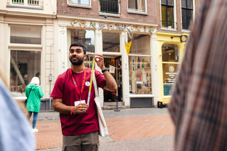 A smiling tour guide in a red t-shirt