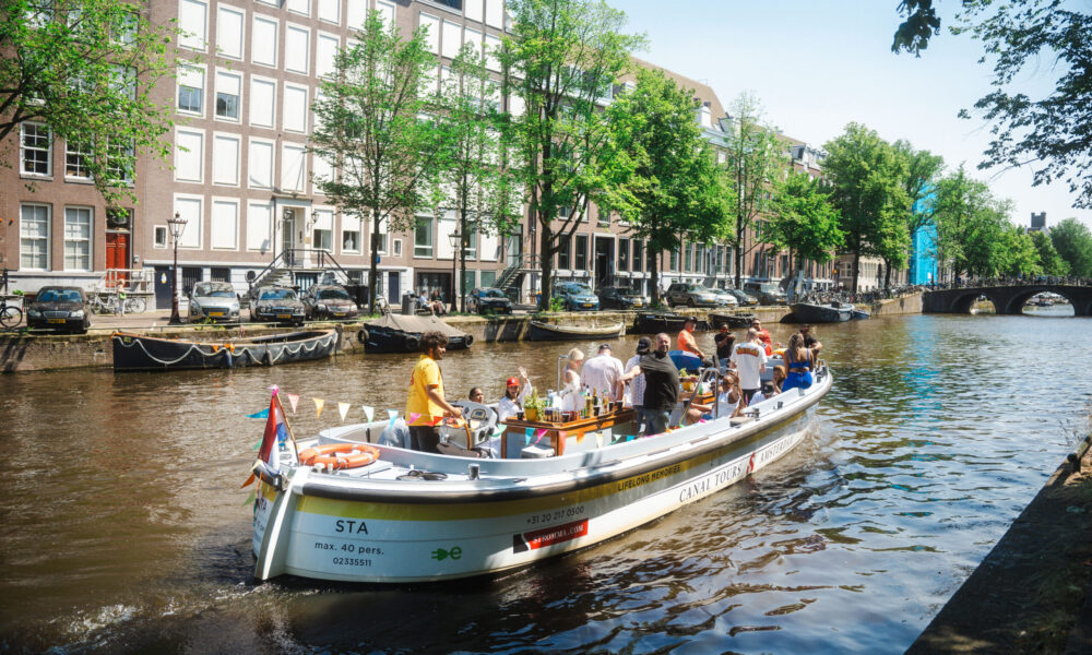 A boat tour on a Amsterdam canal. A group of people on a boat trip.