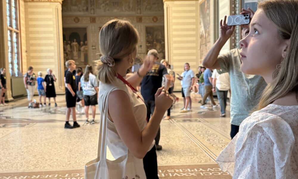 Tourists taking photos in a beautiful interior. Women enjoying sightseeing