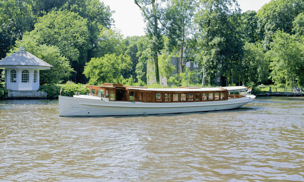 Houseboat on a canal in Amsterdam. A houseboat moored on a waterway.