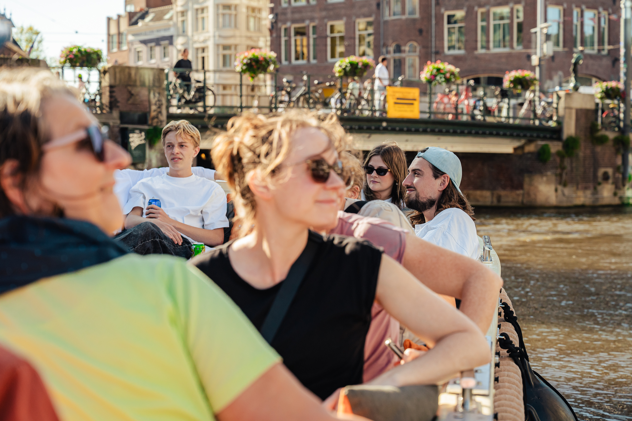 People on a boat looking around. Amsterdam city trip.