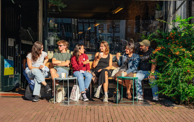 Group of tourists enjoying a drink outside. Casual atmosphere.