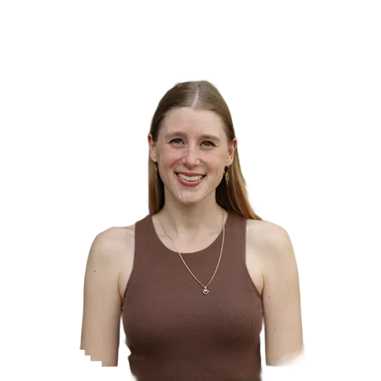 Portrait of a young woman smiling. She is on a city trip to Amsterdam.