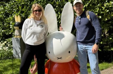 Couple smiling with Miffy statue. Amsterdam city trip